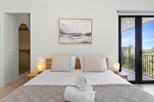 a bedroom with a large bed and a balcony at Meli Apollo Bay in Apollo Bay