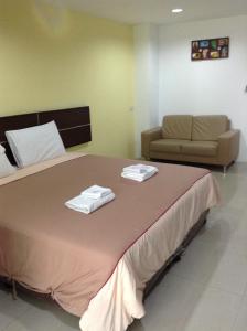 1 dormitorio con 1 cama grande y 2 toallas. en Diamond Bangkok Apartment en Bangkok