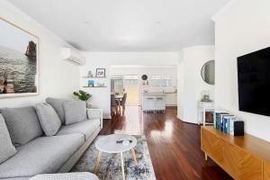a living room with a couch and a table at Bayswater Retreat, 3 Bed house. in Perth