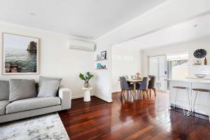 a living room with a couch and a table at Bayswater Retreat, 3 Bed house. in Perth