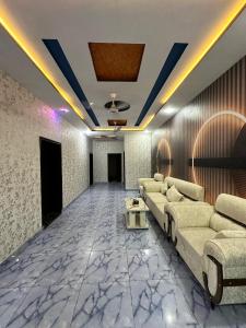 a living room with a couch and a table at Shelton Royal Hotel in Multan