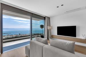 a living room with a couch and a large window at Villa Reina in Makarska