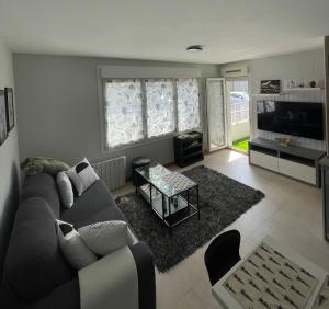 a living room with a couch and a table at Appartement Aldapa in Urrugne