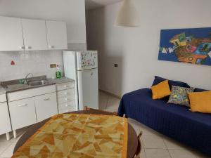 a kitchen with a couch and a sink in a room at Butterfly Apartments in Palermo