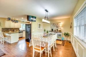 a kitchen and dining room with a table and chairs at 3 Mi to Erie Canal Home with Hot Tub in Holley! in Holley