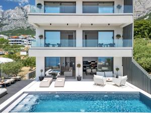 an image of a house with a swimming pool at Villa Reina in Makarska