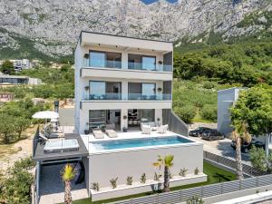 an aerial view of a house with a swimming pool at Villa Reina in Makarska