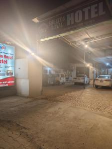 a parking garage with cars parked in it at Shelton Royal Hotel in Multan