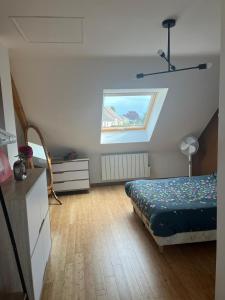 a bedroom with a bed and a window at Maison proche Circuit des 24h du Mans in Saint-Gervais en-Belin