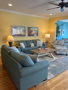 a living room with a couch and a table at Luxurious Bayville Shores Home Close to the Beach! in Selbyville