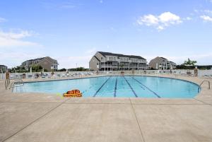 a large swimming pool with a toy in the middle at Luxurious Bayville Shores Home Close to the Beach! in Selbyville