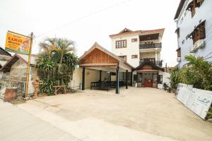 an empty street in a city with buildings at Maylay Guesthouse in Vang Vieng