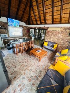 a kitchen and living room with a table and chairs at Bliss in Marloth Park