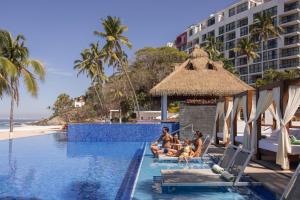 a group of people sitting in a swimming pool at a resort at Hyatt Ziva Puerto Vallarta - All Inclusive in Puerto Vallarta