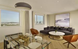 a living room with a couch and a table at Hyatt Regency Paris Etoile in Paris +88 photos