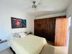 a bedroom with a bed and a wooden door at Spacious and luxurious Yumil Condominium 137m2 in Los Barriles