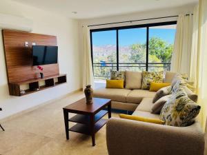 a living room with a couch and a tv at Spacious and luxurious Yumil Condominium 137m2 in Los Barriles