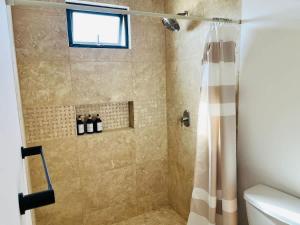 a bathroom with a shower with a shower curtain at Spacious and luxurious Yumil Condominium 137m2 in Los Barriles +26 photos