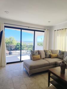a living room with a couch and a large window at Spacious and luxurious Yumil Condominium 137m2 in Los Barriles