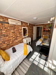 two beds in a room with a brick wall at Bliss in Marloth Park +36 photos
