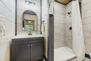 a bathroom with a sink and a shower at Getaway Pointe in Sevierville +18 photos