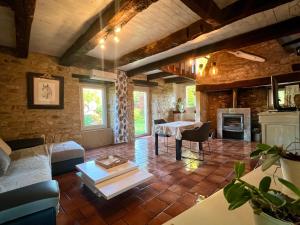 a living room with a couch and a table at Petite maison du causse in Salles-la-Source