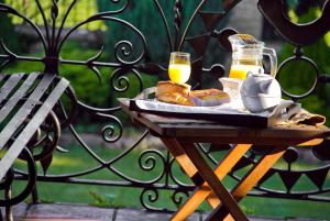 a table with a tray of food and two glasses of orange juice at Posada Real La Montañesa in Los Corrales de Buelna