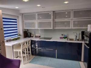 a kitchen with blue cabinets and a counter top at Villa Baneheia-Studios & Apartment in Kristiansand