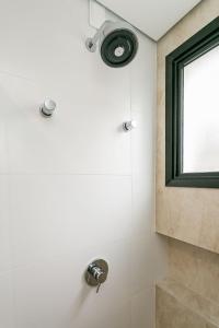 a bathroom with a shower with a window at Piscina com Vista Mar | WI-FI 200mb #CAC01 in Florianópolis +10 photos