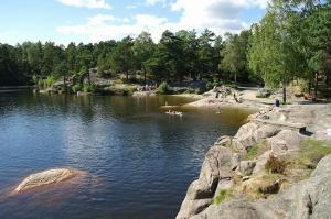 a group of people swimming in a lake at Villa Baneheia-Studios & Apartment in Kristiansand