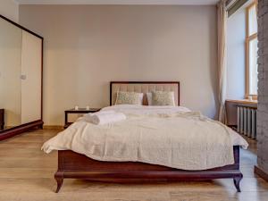 a bedroom with a large bed and a mirror at Old Riga 1BR, Doma Square Views in Rīga