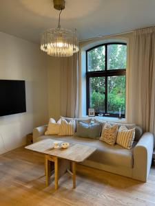 a living room with a couch and a table at Central apt near beach and city life in Kristiansand