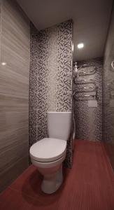 a bathroom with a white toilet and a shower at Giedres Old town studio in Kaunas