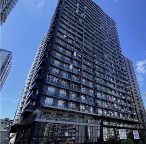 a tall building with many windows in a city at Hedi 18 Apartment in Batumi