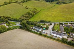 an aerial view of a village with houses and a road at Willow Lodge In Hexton in Hexton