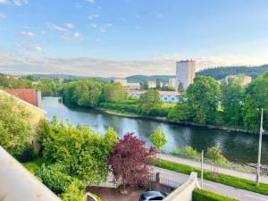 a view of a river from a balcony at Suite Namaste - Cozy Apartment in Épinal