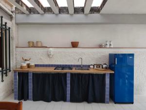 a kitchen with a sink and a blue refrigerator at CASA CELESTE in San Nicola Arcella +43 photos