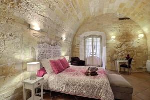 a bedroom with a large bed in a stone wall at appartement centre historique in Bordeaux