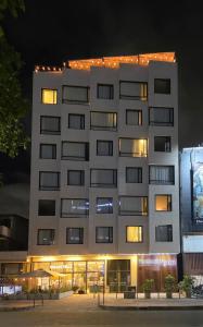 a large white building with lights on top of it at The Hood 102, Modern and Luxury Apartments in Bogotá