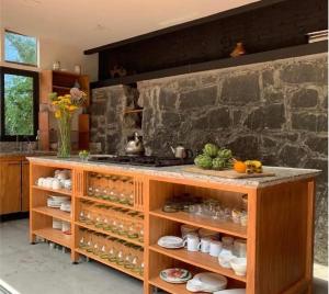 a kitchen with a counter with jars and dishes at Casa Moctezuma in Mexico City