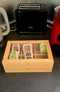 a wooden box with food in front of a toaster at Las Americas Blue Ocean Apartment in Costa de Adeje