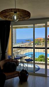 a room with a balcony with a view of a pool at Las Americas Blue Ocean Apartment in Costa de Adeje