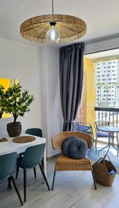 a dining room with a table and a chair and a ceiling at Las Americas Blue Ocean Apartment in Costa de Adeje