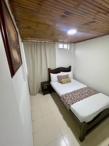 Rúm í herbergi á Hotel Tucan Pereira