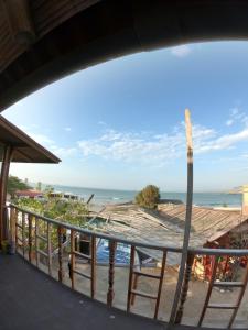 a view of the beach from the balcony of a house at Hotel Relajate in Lobitos
