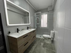 a bathroom with a sink and a toilet and a mirror at El Bierzo - Ponferrada in Ponferrada +11 photos