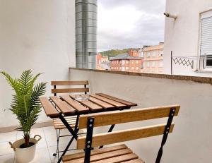 a wooden table and bench on a balcony at El Bierzo - Ponferrada in Ponferrada