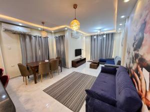 a living room with a couch and a dining room at ستيلا هايتس الساحل الشمالي in Sīdī ‘Abd ar Raḩmān