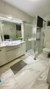 a bathroom with a sink and a shower and a toilet at Marko's Place in Hanioti +45 photos