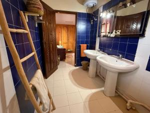 a bathroom with two sinks and a mirror at Villa La Somone piscine jardin personnel sur place in Somone